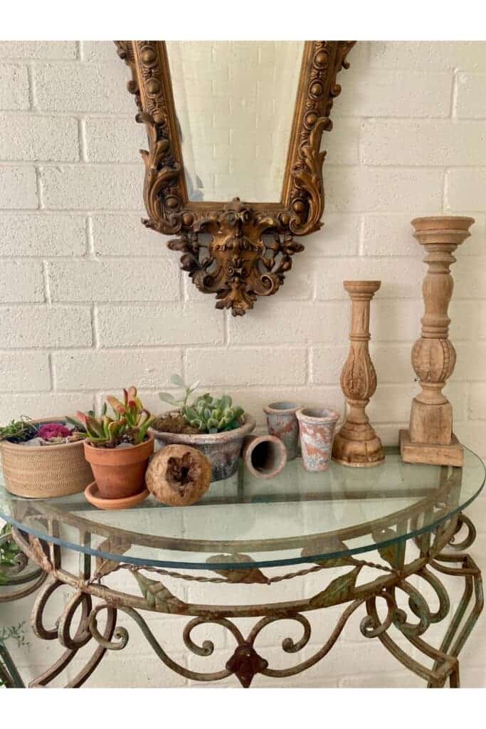 I have an old iron table with a glass top and a mirror to the left of the front door on my front porch.
MySimpaticoLife.com