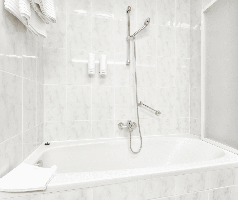 Bathroom with a bathtub and handheld shower and grab bar for aging in place